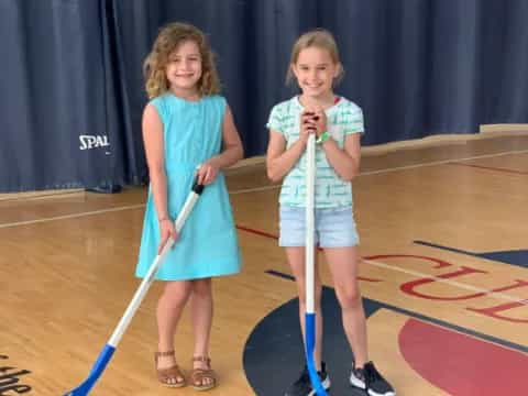 a couple of girls holding tennis rackets