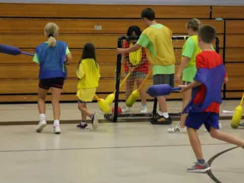 a group of kids playing volleyball