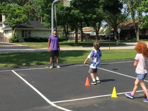 a group of people playing in a parking lot