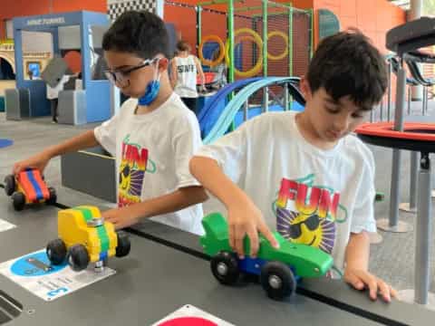 a couple of boys playing with toys