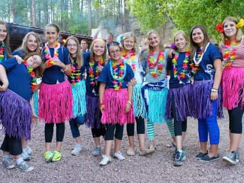 a group of girls in colorful dresses