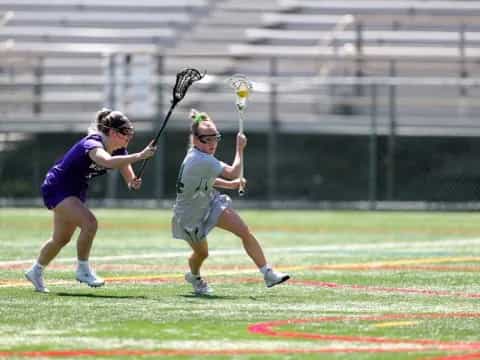 a man and a woman playing lacrosse