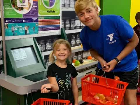 a person and a girl at a grocery store