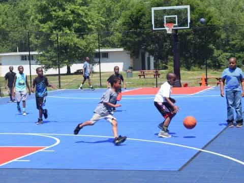 a group of kids playing basketball