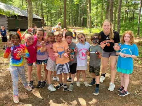 a group of children posing for a photo in the woods
