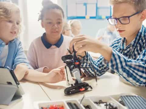 a group of people looking at a microscope