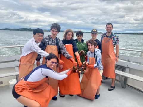a group of people posing for a photo on a boat