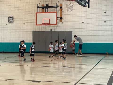 a group of people playing basketball