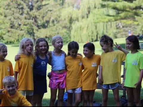a group of children in yellow shirts