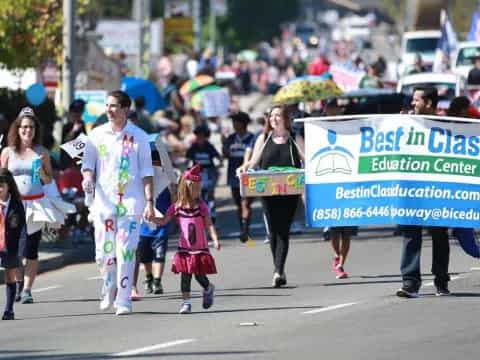 a group of people walking down a street holding a sign