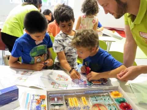 a person showing kids something on a paper