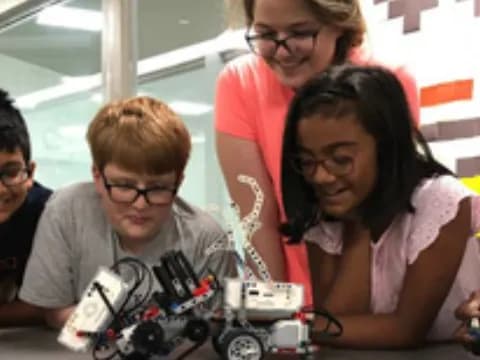 a group of people looking at a toy car