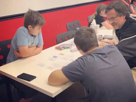 a group of people sitting around a table