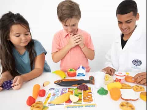 a group of people sitting at a table with food