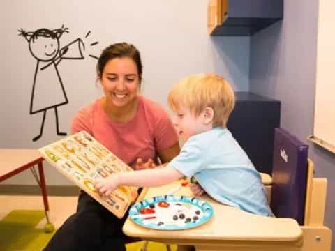 a person and a child sitting at a table