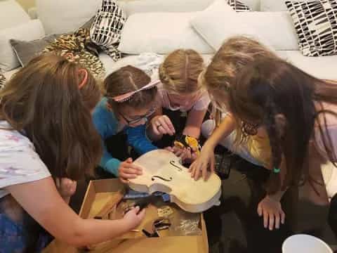 a group of girls playing with a toy