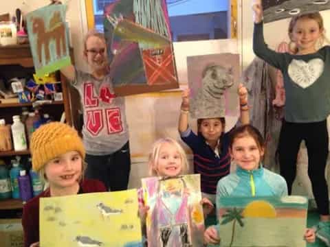 a group of people holding up colorful paper