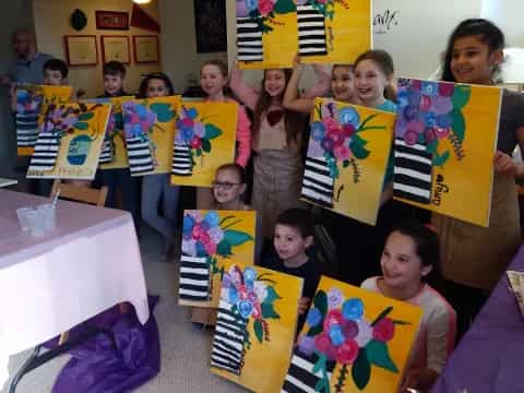 a group of children holding up colorful flags