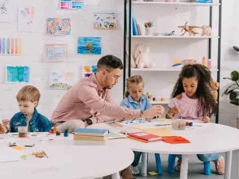 a person and children sitting at a table