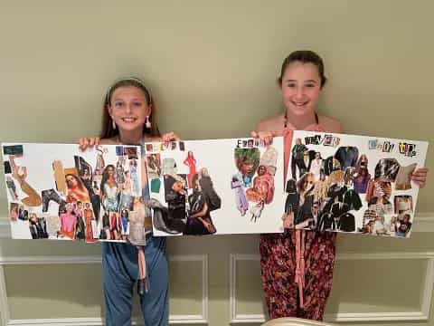 a boy and girl holding up a picture of a person