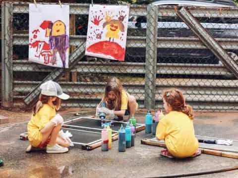 a group of people sitting on the ground outside