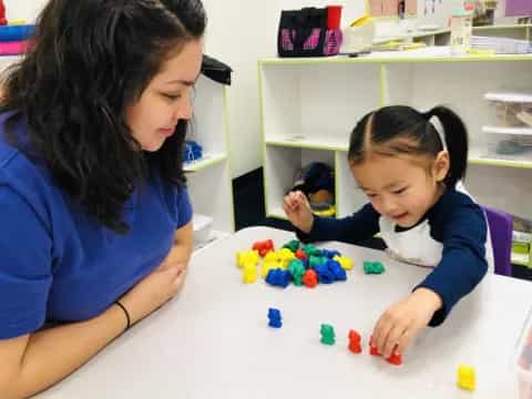 a person and a child playing with toys