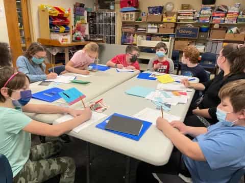 a group of children sitting at a table