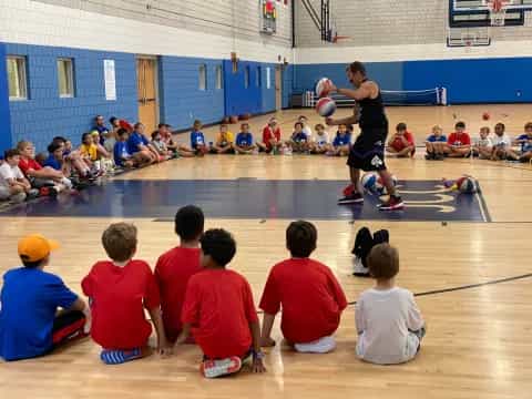 a group of kids playing basketball