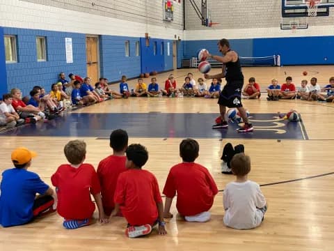 a group of kids playing basketball