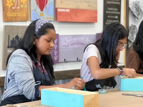 a few young girls sitting at a table