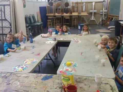 a group of children sitting around a table
