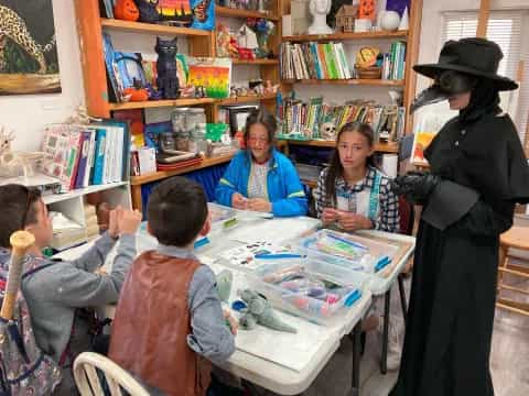 a group of children sitting around a table