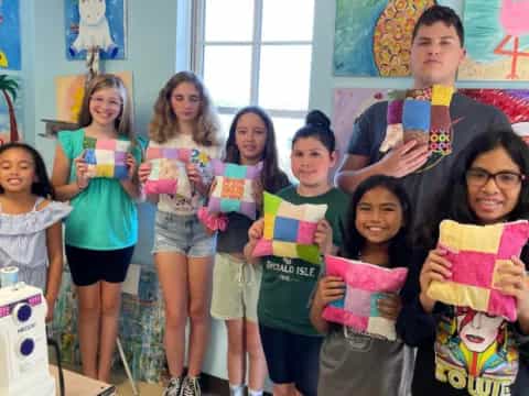 a group of children holding up books