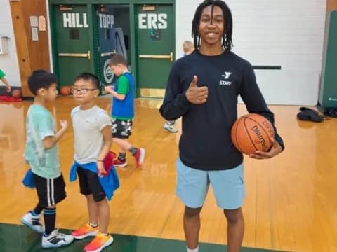 a person holding a basketball and a group of kids