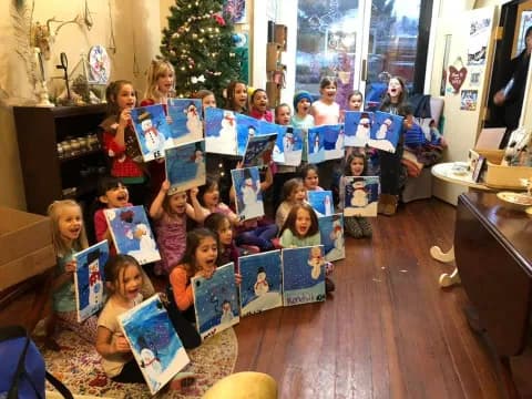 a group of children holding up books