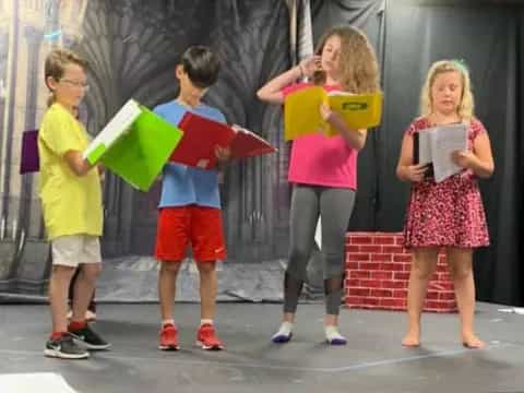 a group of children holding umbrellas