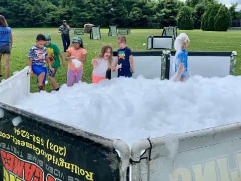 a group of children playing in a water fountain