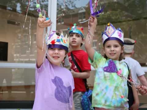 a group of children wearing party hats