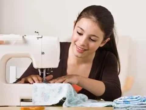 a person looking at a sewing machine