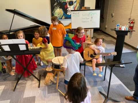 a group of kids playing instruments