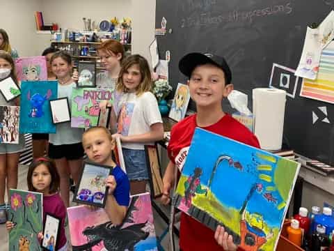 a group of children holding up posters