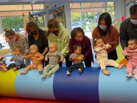a group of people sitting on a blue mat