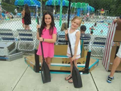 a couple of girls holding skateboards