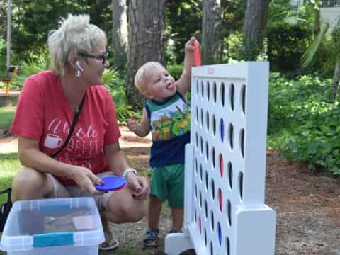a person and a child looking at a sign