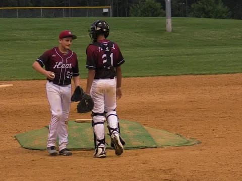 a couple of baseball players on a field