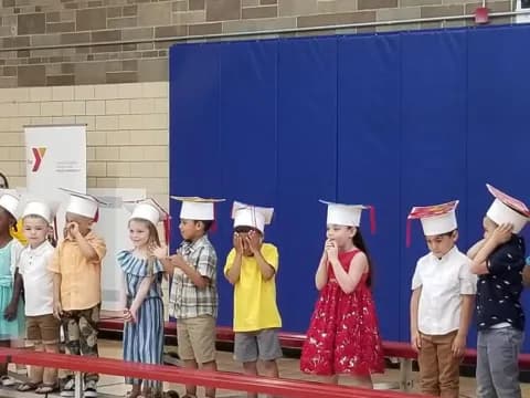 a group of children wearing white hats