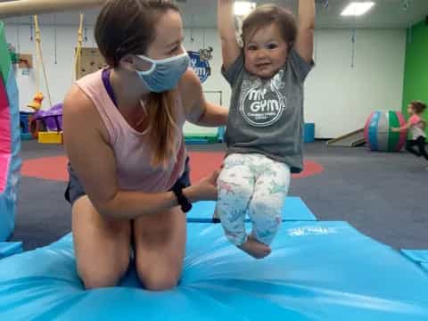 a couple of children on a trampoline