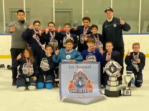 a group of people posing for a photo with a trophy
