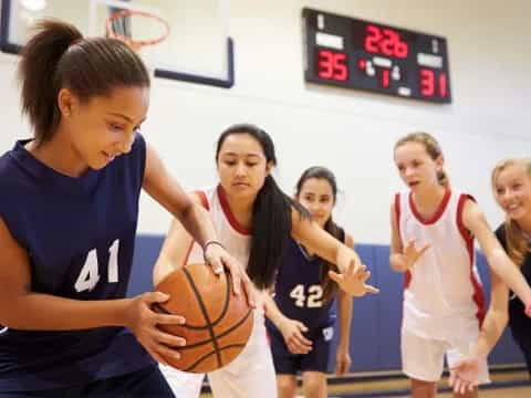 a group of women playing basketball
