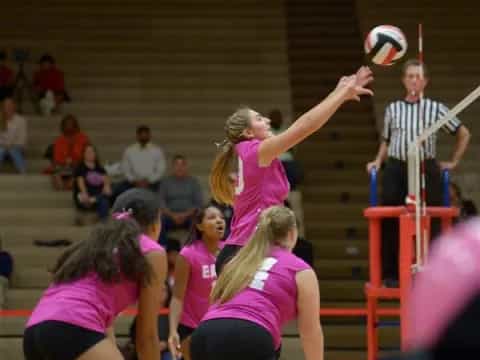 a group of people playing volleyball